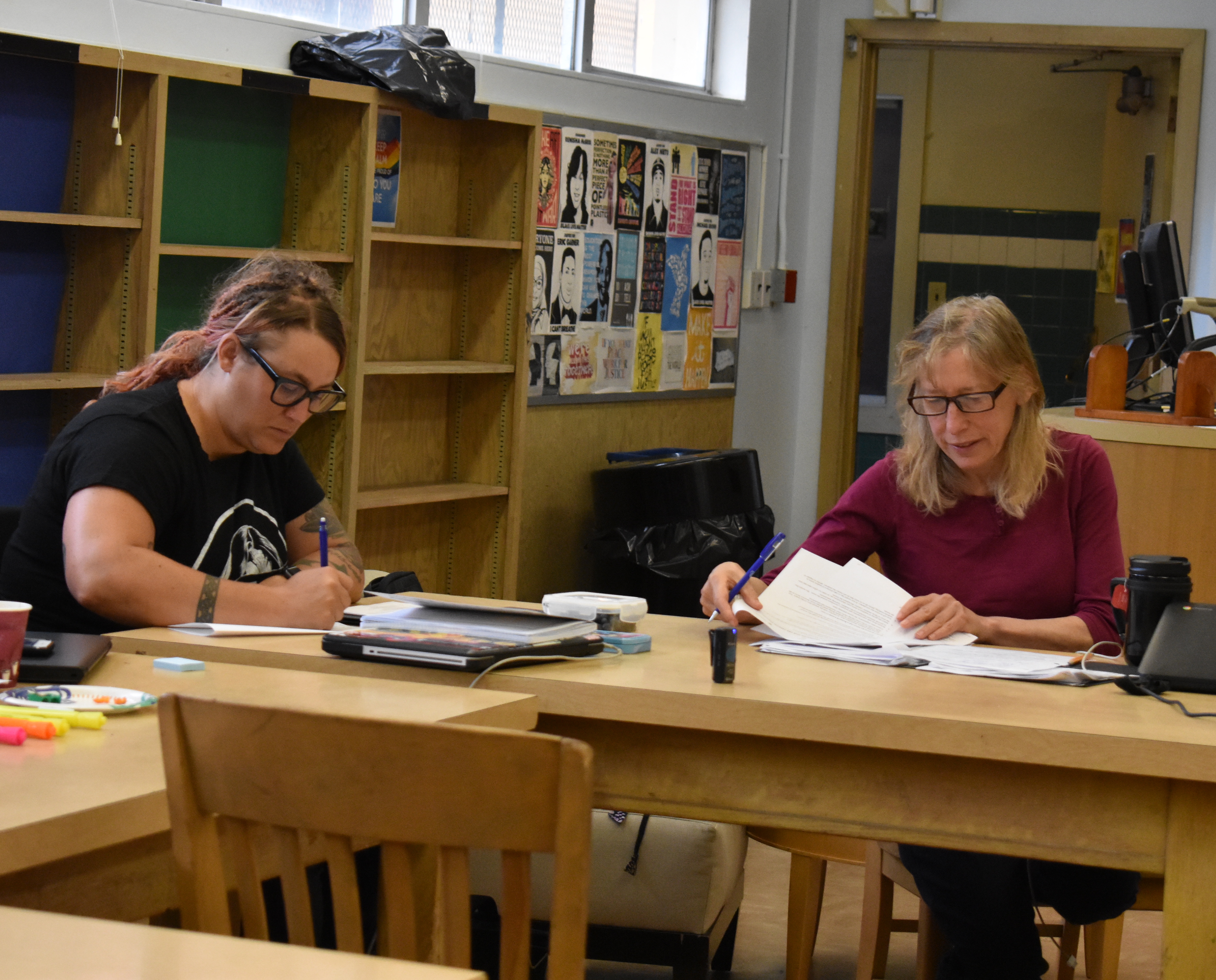 Two teachers review notes taken during their observation of a research lesson