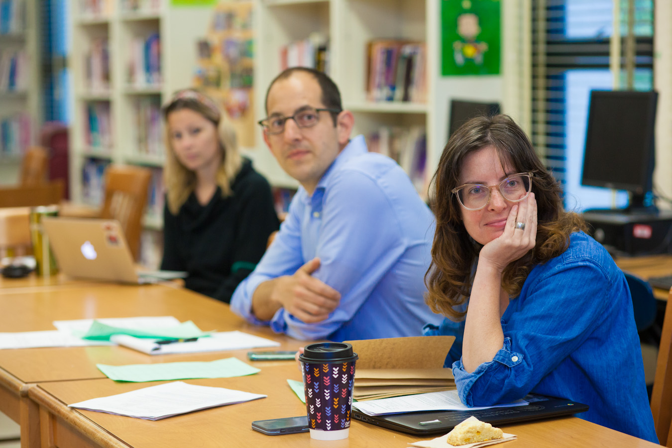 Boy pointing and teacher watching An elementary-age male student points while his female teacher stands beside him and observes