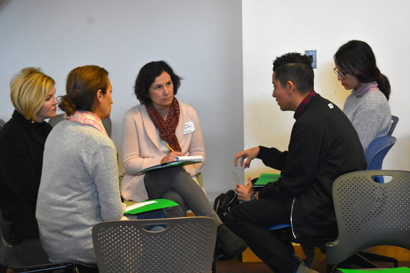 teachers-talking-intensely_optimized Teachers sit in chairs in a circle having a focused conversation