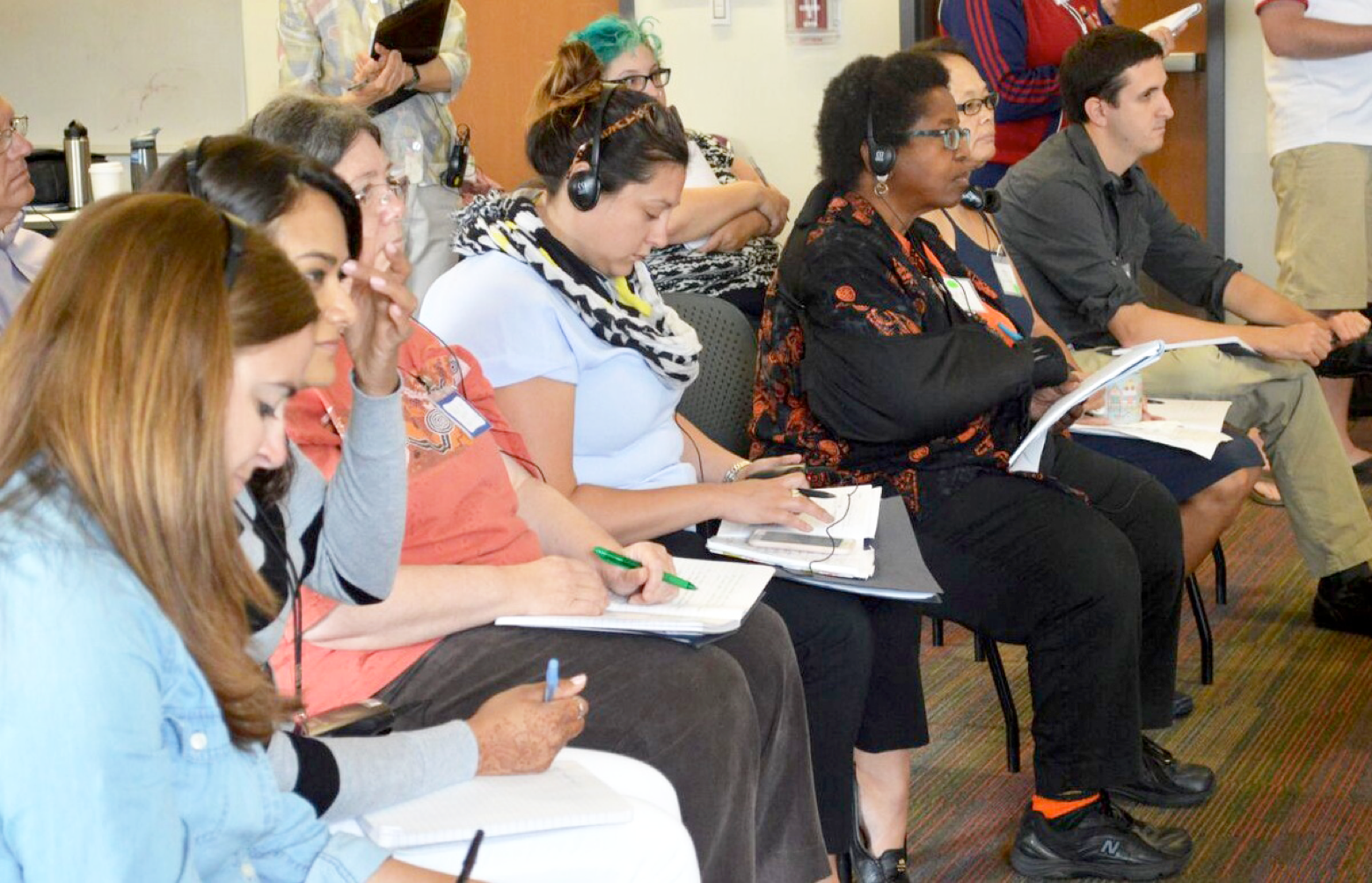 A student explains his mathematical idea as a teacher records the student's thoughts on a white board